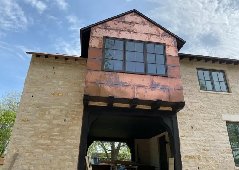 Copper metal panel facade on a stone building for Metal Roof Coating in Howell